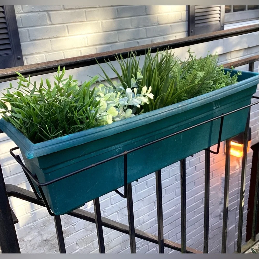 3 faux green plants in pots.